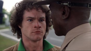 Movie still from “An Officer and a Gentleman” (1982), directed by Taylor Hackford – A man and a man in a hat talking to each other; Close Up shot, Over the shoulder angle