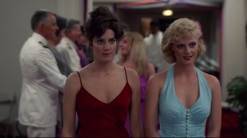 Movie still from “An Officer and a Gentleman” (1982), directed by Taylor Hackford – A couple of women standing next to each other in dresses; Medium shot, Low angle