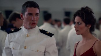 Movie still from “An Officer and a Gentleman” (1982), directed by Taylor Hackford – A man and a woman in military dress uniforms; Medium shot, Over the shoulder angle