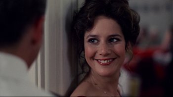 Movie still from “An Officer and a Gentleman” (1982), directed by Taylor Hackford – A person smiling at the camera; Close Up shot, Over the shoulder angle