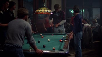 Movie still from “An Officer and a Gentleman” (1982), directed by Taylor Hackford – A group of people playing a game of billiards; Wide shot, High angle