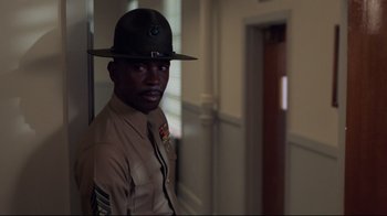 Movie still from “An Officer and a Gentleman” (1982), directed by Taylor Hackford – A man in a uniform is standing in a hallway; Close Up shot, Low angle