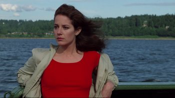 Movie still from “An Officer and a Gentleman” (1982), directed by Taylor Hackford – A woman in a red shirt is standing by a body of water; Medium shot, Low angle