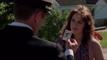 Movie still from “An Officer and a Gentleman” (1982), directed by Taylor Hackford – A woman holding a picture of a man in a uniform; Close Up shot, Over the shoulder angle