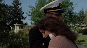 Movie still from “An Officer and a Gentleman” (1982), directed by Taylor Hackford – A man and a woman in military uniforms hugging each other; Medium shot, Low angle