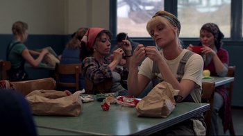 Movie still from “An Officer and a Gentleman” (1982), directed by Taylor Hackford – Two women sitting at a table eating food; Medium shot, Low angle