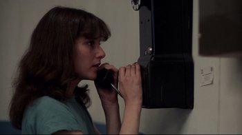 Movie still from “An Officer and a Gentleman” (1982), directed by Taylor Hackford – A young woman is talking on a phone; Close Up shot, Low angle