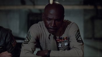 Movie still from “An Officer and a Gentleman” (1982), directed by Taylor Hackford – A man in uniform sitting in a dark room; Close Up shot, Low angle