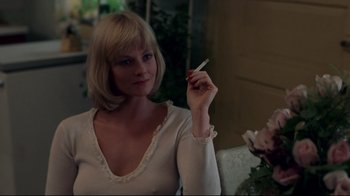 Movie still from “An Officer and a Gentleman” (1982), directed by Taylor Hackford – A woman is holding a cigarette in her hand; Close Up shot, Low angle