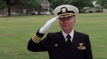 Movie still from “An Officer and a Gentleman” (1982), directed by Taylor Hackford – A man saluting while wearing a military uniform; Medium shot, Low angle
