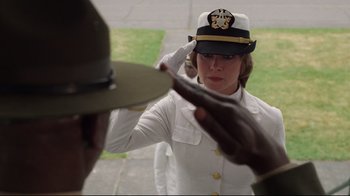 Movie still from “An Officer and a Gentleman” (1982), directed by Taylor Hackford – A woman saluting a man wearing a hat; Close Up shot, Low angle