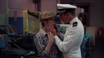 Movie still from “An Officer and a Gentleman” (1982), directed by Taylor Hackford – A man and a woman in a hat and uniform; Medium shot, Over the shoulder angle
