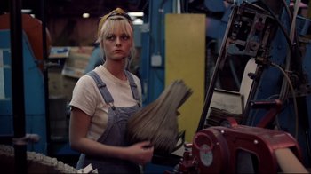 Movie still from “An Officer and a Gentleman” (1982), directed by Taylor Hackford – A woman holding a broom in her hands; Medium shot, Low angle