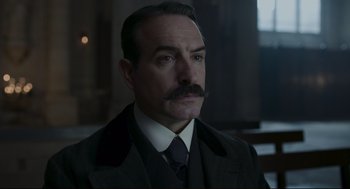 Movie still from “An Officer and a Spy” (2019), directed by Roman Polanski – A person wearing a suit and a tie; Close Up shot, Low angle