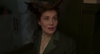 Movie still from “An Officer and a Spy” (2019), directed by Roman Polanski – A woman wearing a green jacket and a hat; Close Up shot, High angle