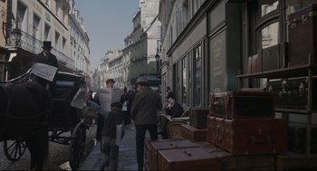 Movie still from “An Officer and a Spy” (2019), directed by Roman Polanski – A group of people walking down a street; Wide shot, High angle