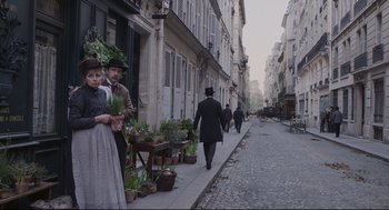 Movie still from “An Officer and a Spy” (2019), directed by Roman Polanski – A group of people walking down a street; Wide shot, High angle