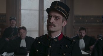 Movie still from “An Officer and a Spy” (2019), directed by Roman Polanski – A man wearing a uniform and a hat; Close Up shot, Low angle