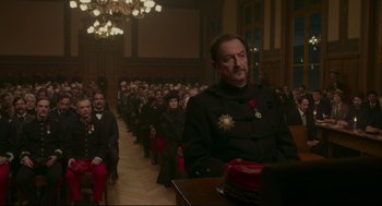 Movie still from “An Officer and a Spy” (2019), directed by Roman Polanski – A group of people sitting in front of a crowd; Medium shot, High angle