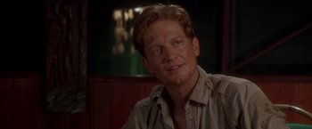 Movie still from “Anaconda” (1997), directed by Luis Llosa – A person wearing a tan shirt; Close Up shot, Over the shoulder angle