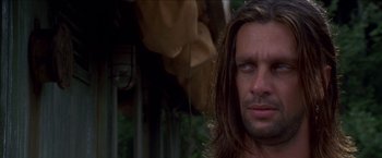 Movie still from “Anaconda” (1997), directed by Luis Llosa – A person with long brown hair; Close Up shot, Over the shoulder angle