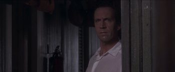 Movie still from “Anaconda” (1997), directed by Luis Llosa – A person wearing a white shirt; Close Up shot, Low angle