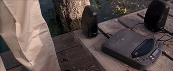 Movie still from “Anaconda” (1997), directed by Luis Llosa – A speaker on the ground next to a laptop; Close Up shot, High angle