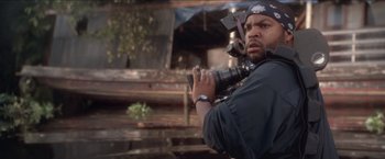Movie still from “Anaconda” (1997), directed by Luis Llosa – A man holding a camera in his hands; Close Up shot, Over the shoulder angle