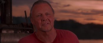 Movie still from “Anaconda” (1997), directed by Luis Llosa – An older man is looking at the camera; Close Up shot, Low angle