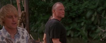 Movie still from “Anaconda” (1997), directed by Luis Llosa – A man standing in front of a body of water; Close Up shot, Over the shoulder angle