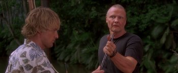 Movie still from “Anaconda” (1997), directed by Luis Llosa – A man holding a pair of scissors in front of a mirror; Close Up shot, Over the shoulder angle