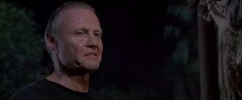 Movie still from “Anaconda” (1997), directed by Luis Llosa – A person wearing a black t - shirt; Close Up shot, Low angle