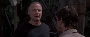 Movie still from “Anaconda” (1997), directed by Luis Llosa – A man in a black t - shirt talking to another man in a black t - shirt; Close Up shot, Low angle