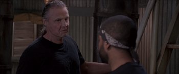 Movie still from “Anaconda” (1997), directed by Luis Llosa – A man in black shirt talking to another man in black shirt; Close Up shot, Over the shoulder angle