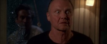 Movie still from “Anaconda” (1997), directed by Luis Llosa – An older man stares into the distance with a creepy look on his face; Close Up shot, Low angle