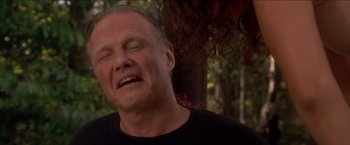 Movie still from “Anaconda” (1997), directed by Luis Llosa – An older man with long white hair is crying; Close Up shot, Low angle