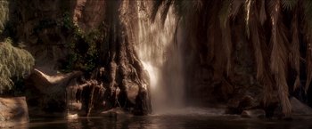 Movie still from “Anaconda” (1997), directed by Luis Llosa – A large waterfall with water pouring over it's side; Extreme Wide shot, Low angle