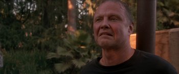 Movie still from “Anaconda” (1997), directed by Luis Llosa – A person wearing a black t - shirt; Close Up shot, Low angle