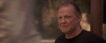 Movie still from “Anaconda” (1997), directed by Luis Llosa – An older man is looking at the camera; Close Up shot, Low angle