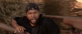 Movie still from “Anaconda” (1997), directed by Luis Llosa – Ice cube in a black shirt and a black hat; Close Up shot, High angle