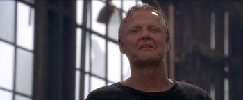 Movie still from “Anaconda” (1997), directed by Luis Llosa – A person wearing a black shirt; Close Up shot, Low angle