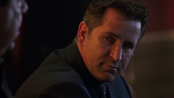 Movie still from “Analyze That” (2002), directed by Harold Ramis – A person wearing a suit; Close Up shot, Low angle