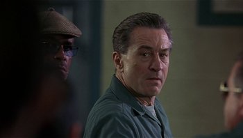 Movie still from “Analyze That” (2002), directed by Harold Ramis – A person wearing a hat; Close Up shot, Over the shoulder angle