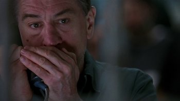 Movie still from “Analyze That” (2002), directed by Harold Ramis – A person talking on a phone; Close Up shot, Low angle