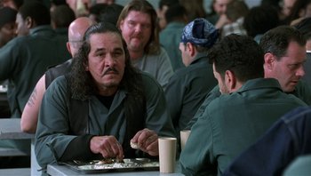 Movie still from “Analyze That” (2002), directed by Harold Ramis – A group of men sitting at a table eating food; Medium shot, Over the shoulder angle
