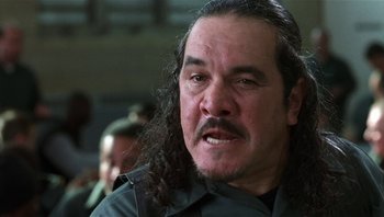 Movie still from “Analyze That” (2002), directed by Harold Ramis – A person with long black hair; Close Up shot, Low angle