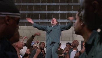 Movie still from “Analyze That” (2002), directed by Harold Ramis – A group of men standing in a room; Medium shot, Low angle