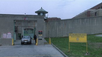 Movie still from “Analyze That” (2002), directed by Harold Ramis – A car parked in front of a jail cell; Extreme Wide shot, High angle