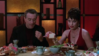 Movie still from “Analyze That” (2002), directed by Harold Ramis – A man and a woman sitting at a dinner table; Medium shot, Over the shoulder angle
