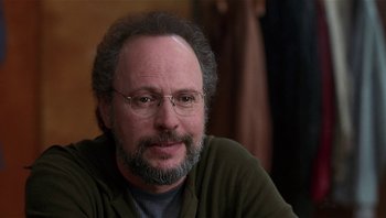 Movie still from “Analyze That” (2002), directed by Harold Ramis – A person with a beard wearing glasses; Close Up shot, Over the shoulder angle